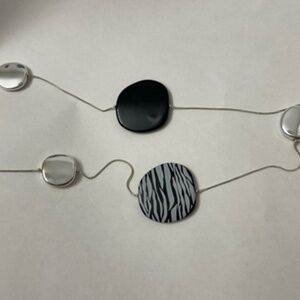 Different sizes and color black and silver necklace